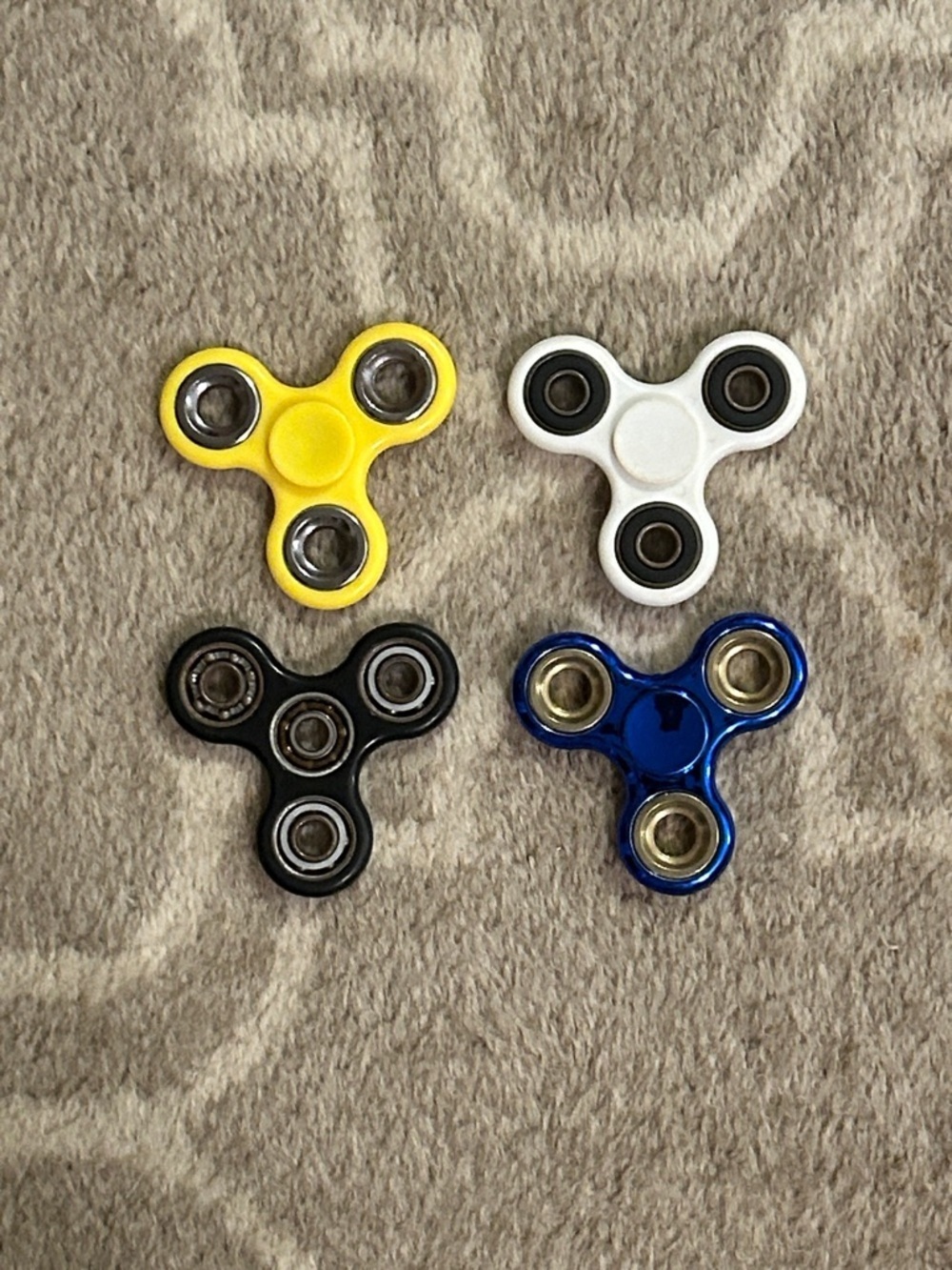 Set of 4 Kids Fidget Spinners - Yellow, White, Black, Blue